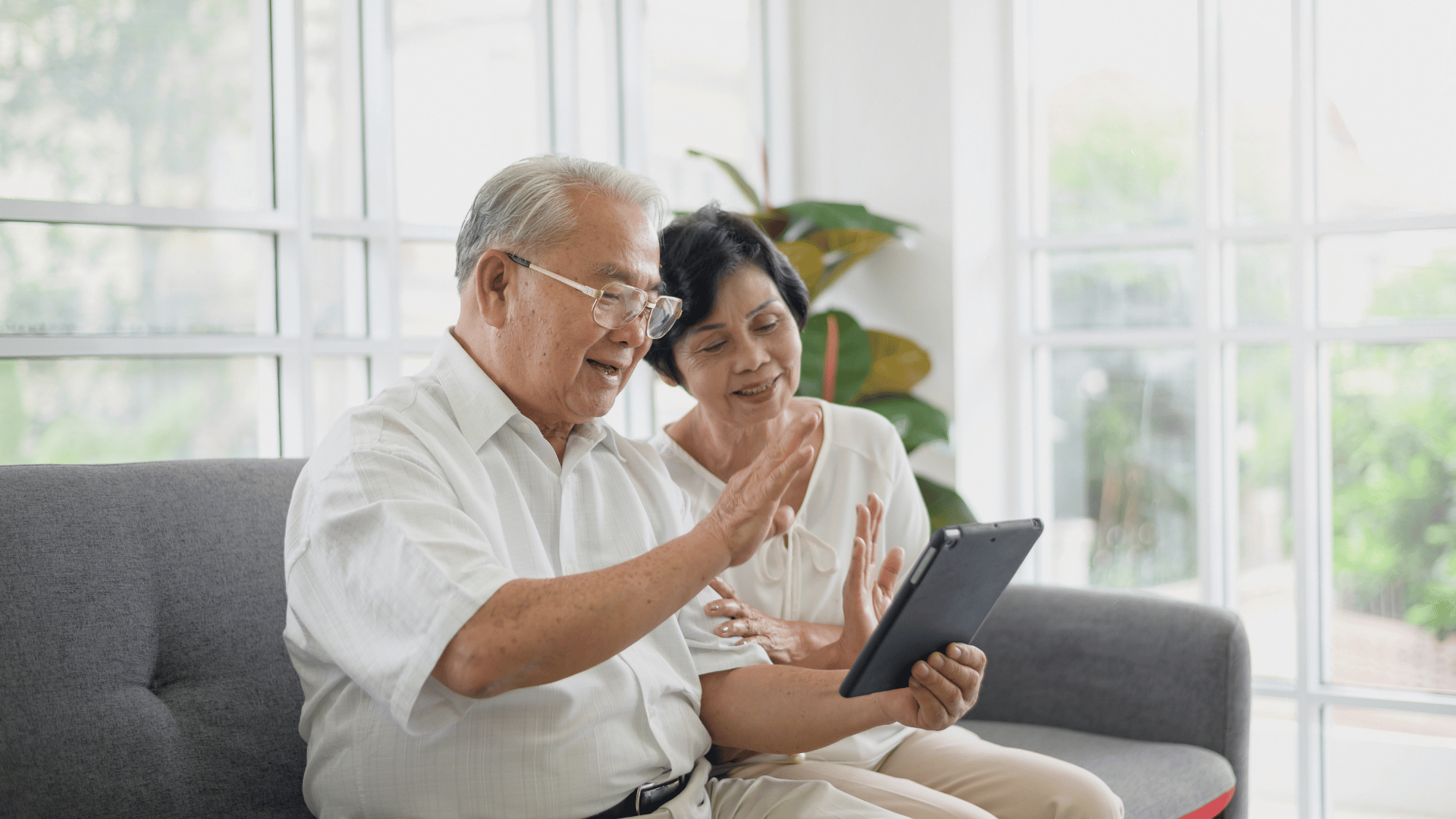 Elderly parents on video phone call with family from a distance