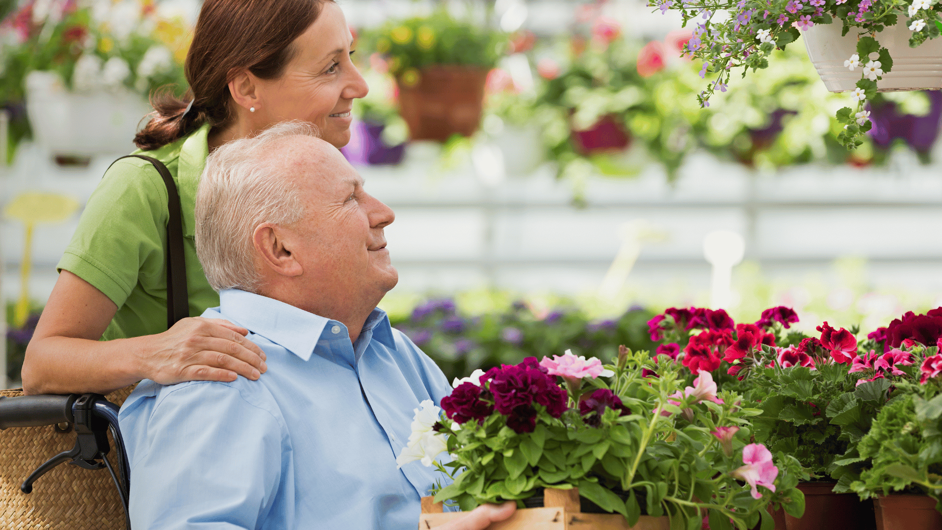 A live-in caregiver with elderly man at a garden