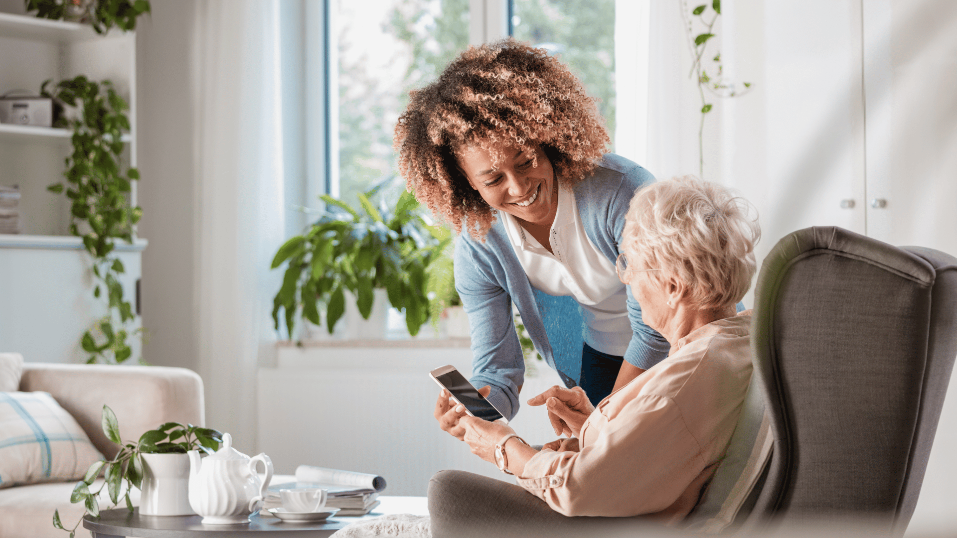 Assisted living caregiver helping elderly woman