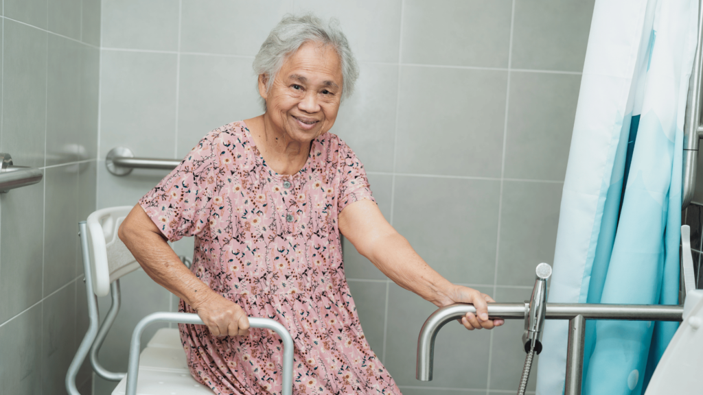 Senior woman receiving bathing assistance from caregiver