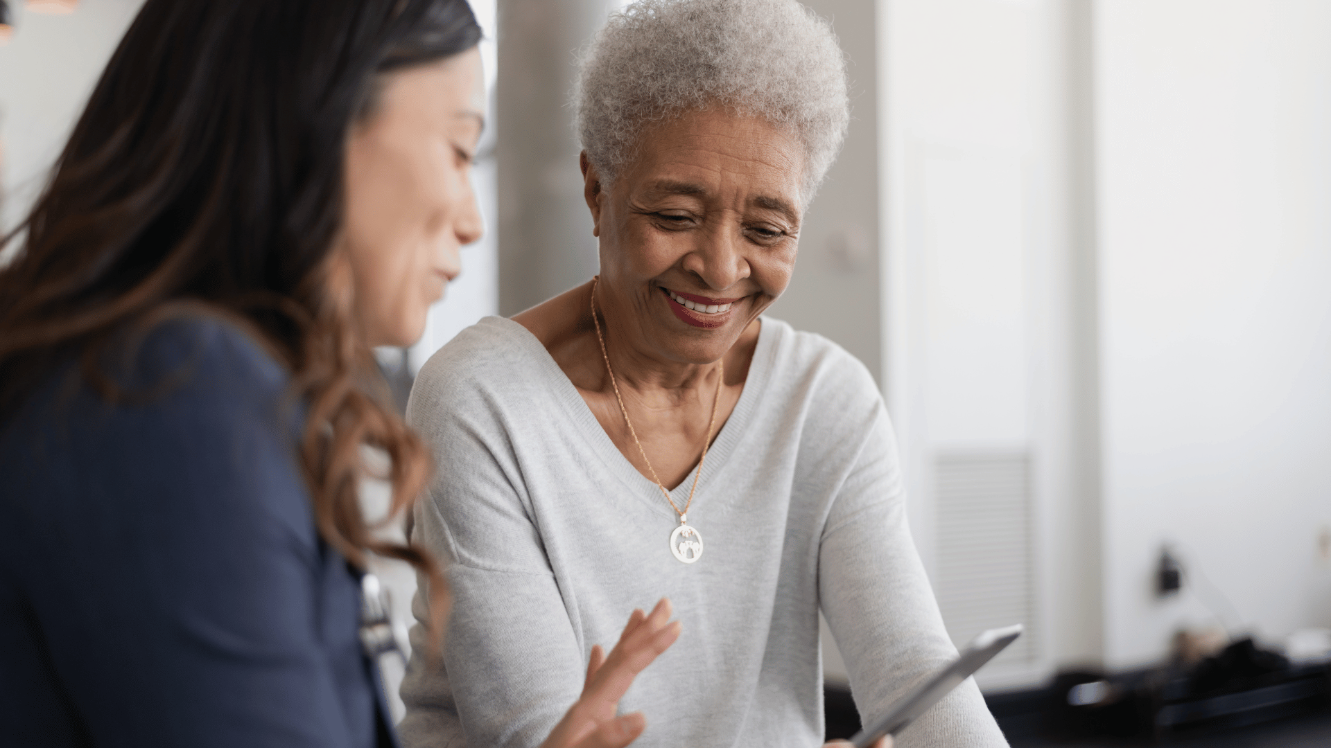 Caregiver explaining personalized care plan to senior