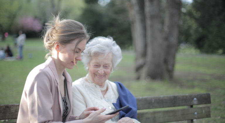 Family member, out in the park with a senior