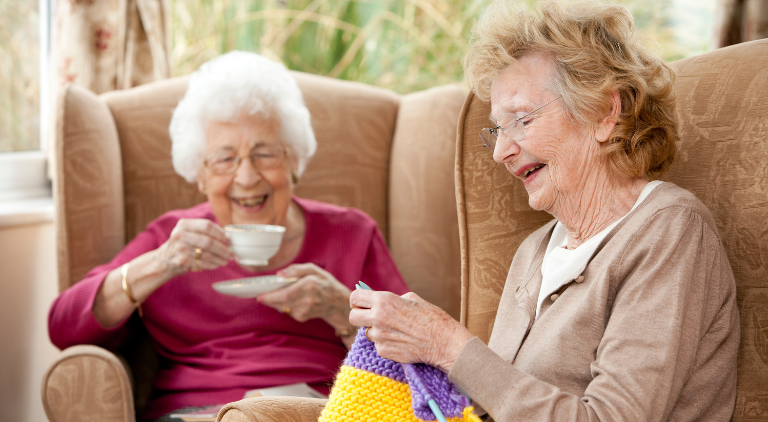Two Elderly people laughing together