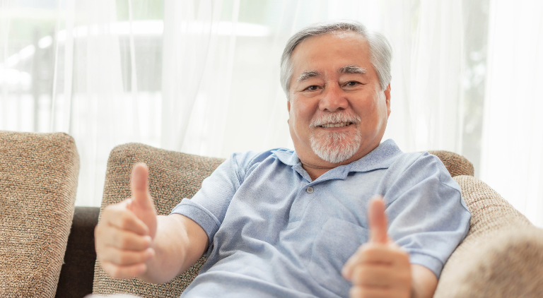 Senior giving two thumbs up towards viewer